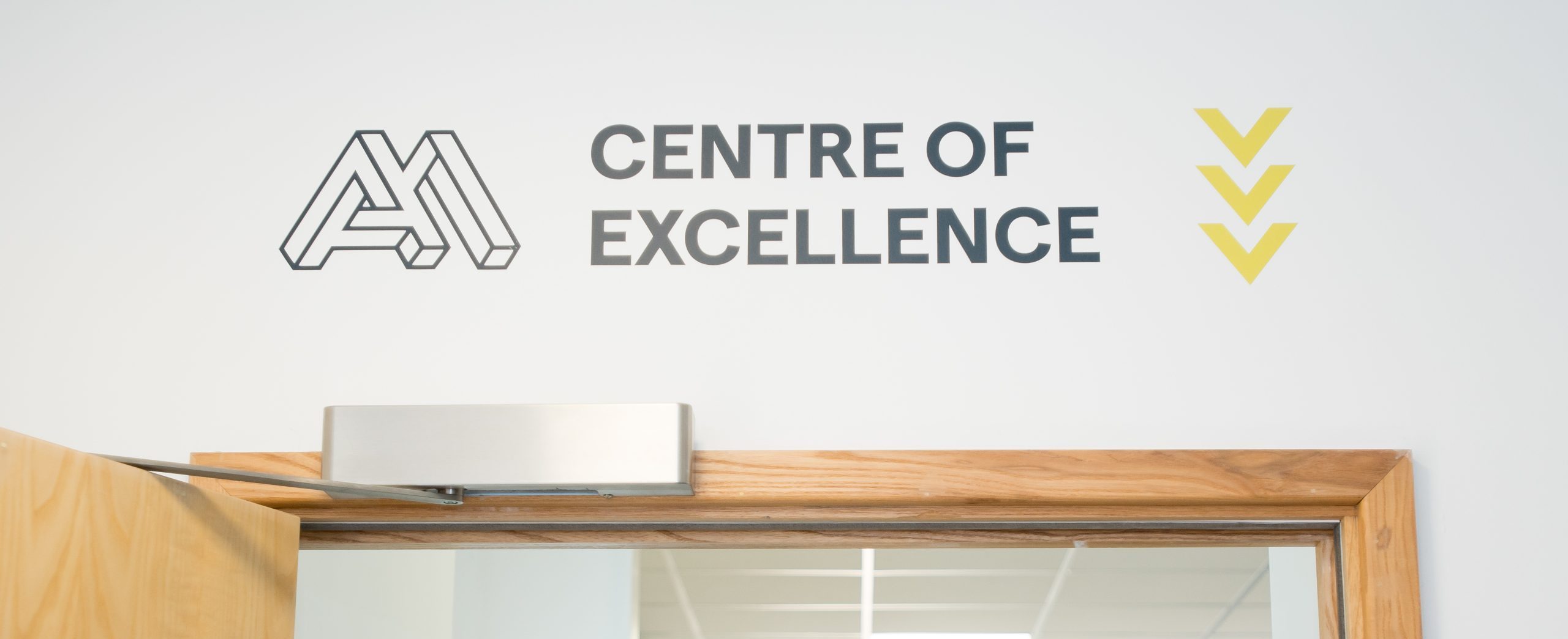 A sign above an open door that reads "Centre of Excellence".