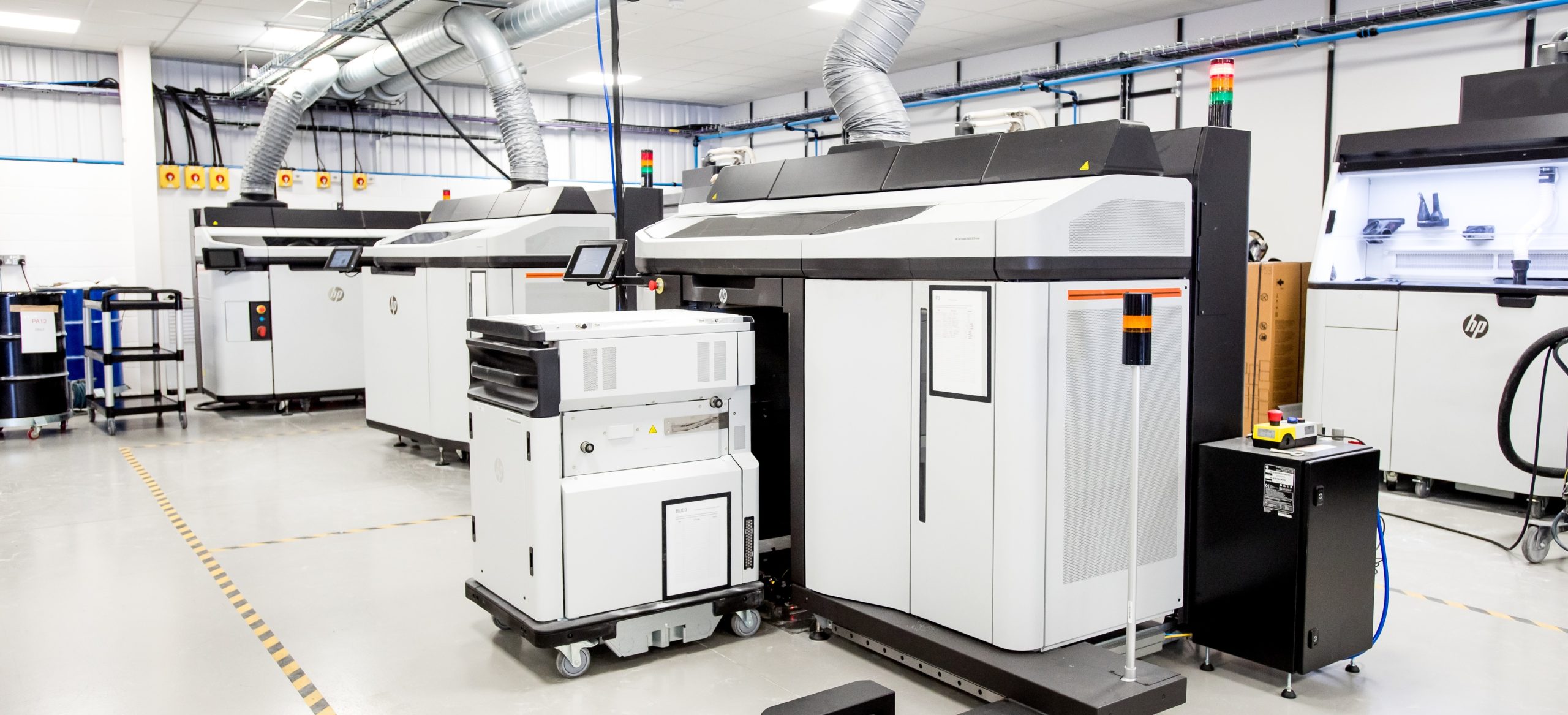 A room with multiple 3D printers and equipment.